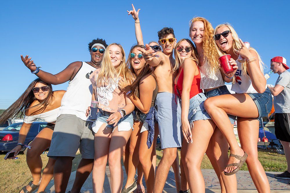 A group of young people are posing for a picture together.