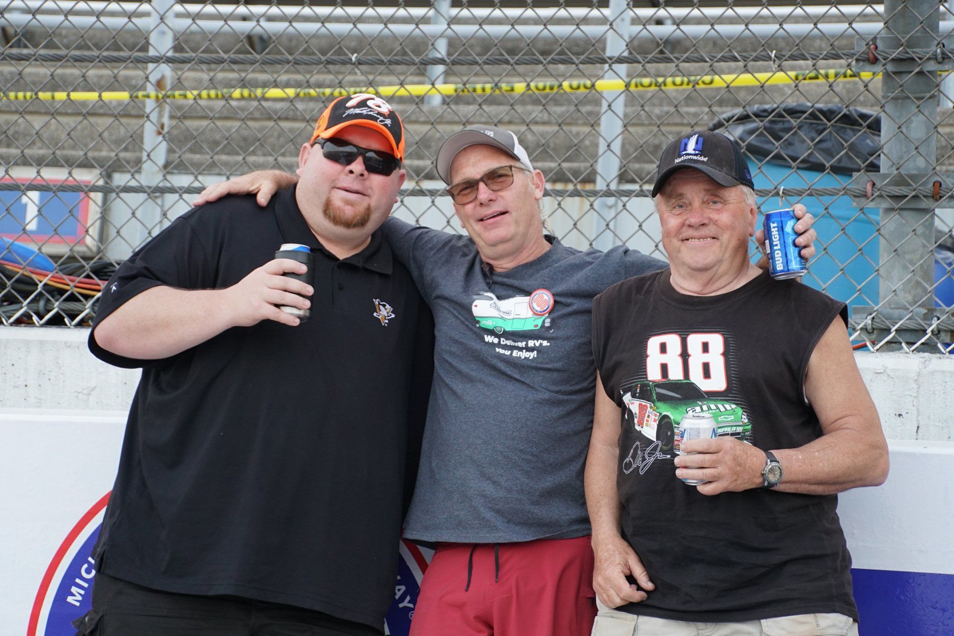 Three men posing for a picture with one wearing a shirt that says 88. 