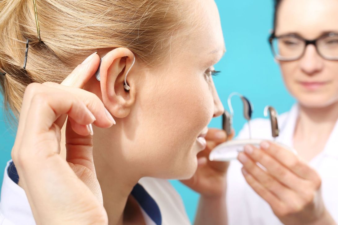 Woman with hearing aid in right ear