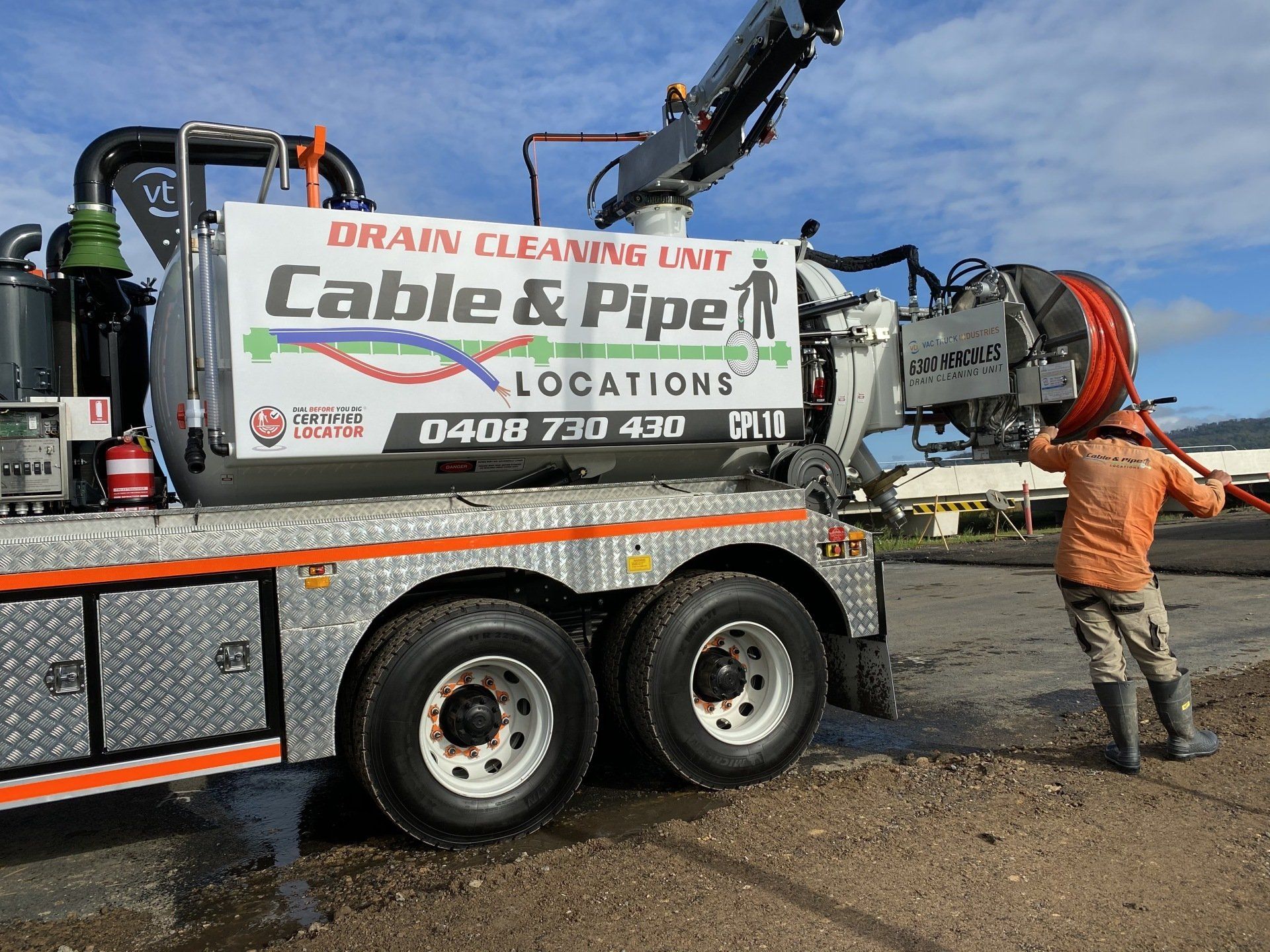 Man In Helmet Is Holding The Cable — Cable & Pipe Locations in Woolgoolga, NSW