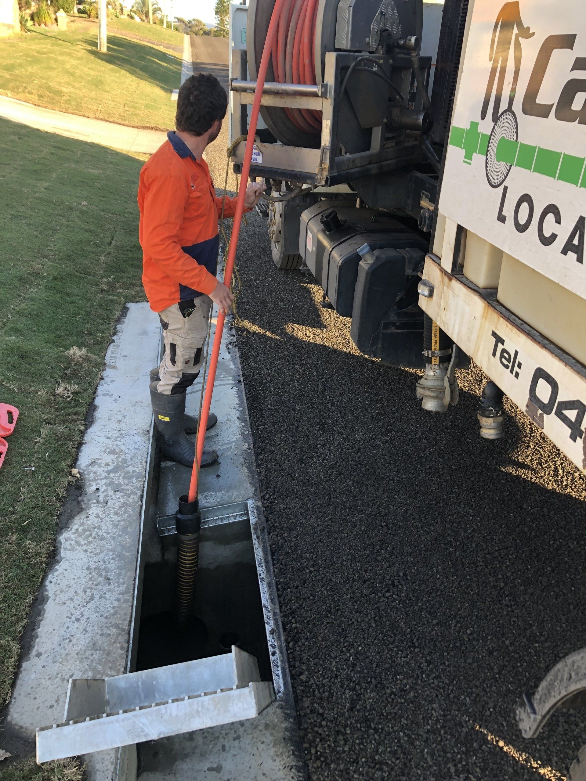 Man Cleaning The Sewage — Cable & Pipe Locations in Woolgoolga, NSW
