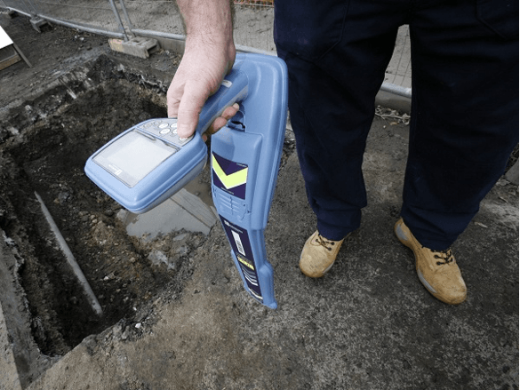 Man Holding A Detector — Cable & Pipe Locations in Woolgoolga, NSW
