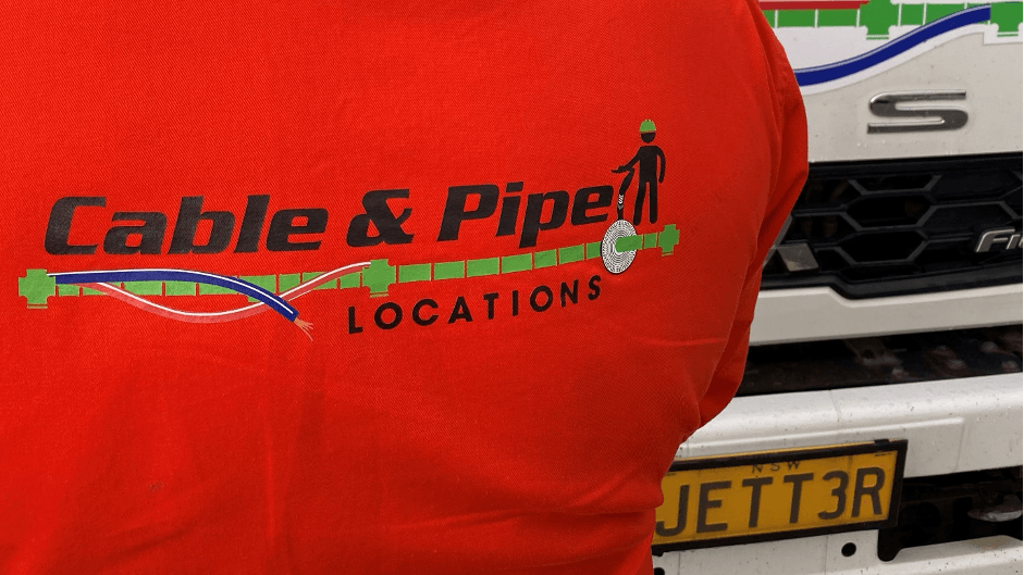 A Person Wearing a Red Shirt that Says Cable & Pipe Locations — Cable & Pipe Locations in Woolgoolga, NSW