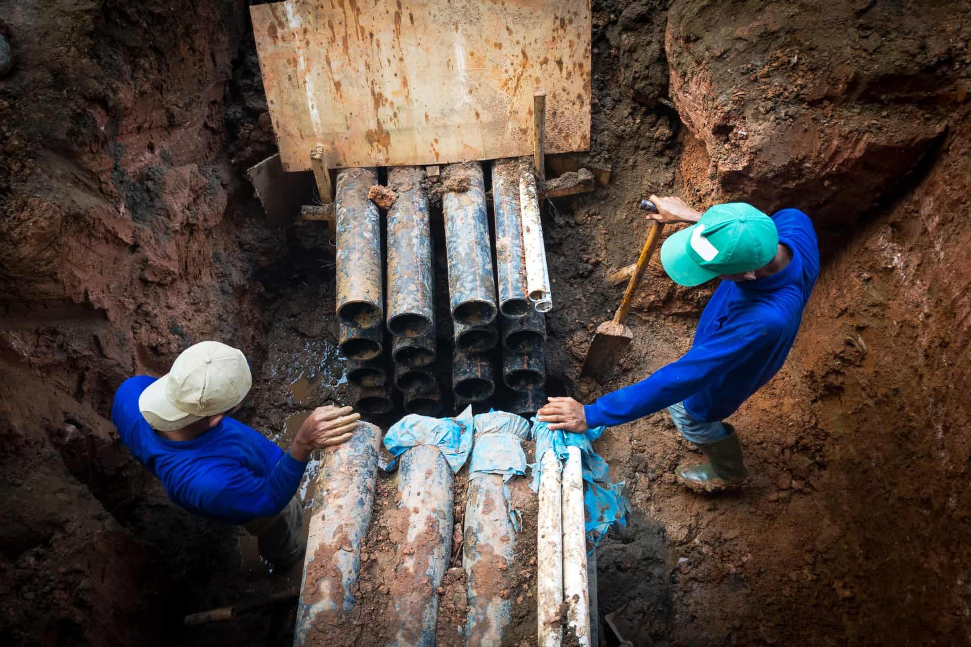 Construction Workers Fixing Underground Pipes— Cable & Pipe Locations in Woolgoolga, NSW