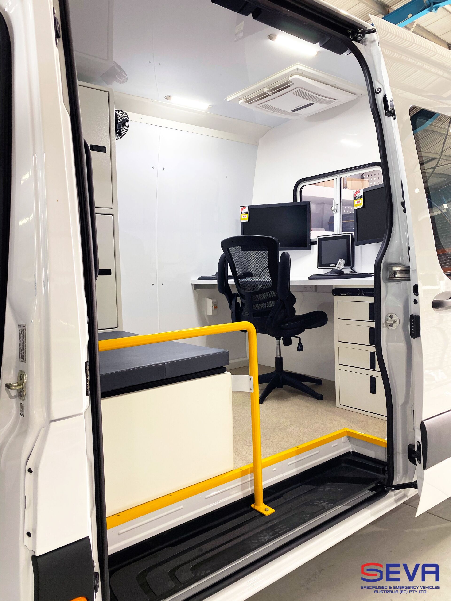 A White Van with A Desk and Chair Inside of It — Cable & Pipe Locations in Woolgoolga, NSW