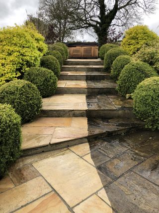 Natural sandstone patio in progress of being cleaned in Poole, Dorset
