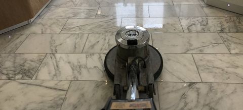 Rotary diamond polishing machine polishing a marble floor