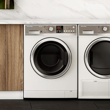 A washer and dryer are sitting next to each other in a laundry room.