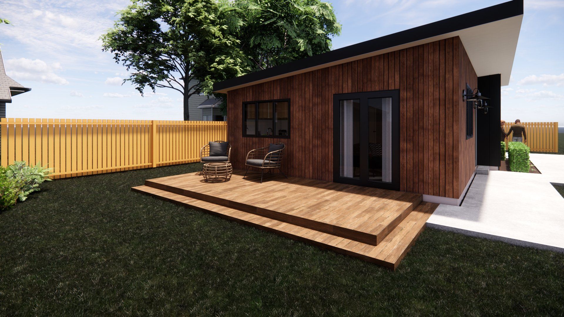 A small house with a wooden deck in the backyard.