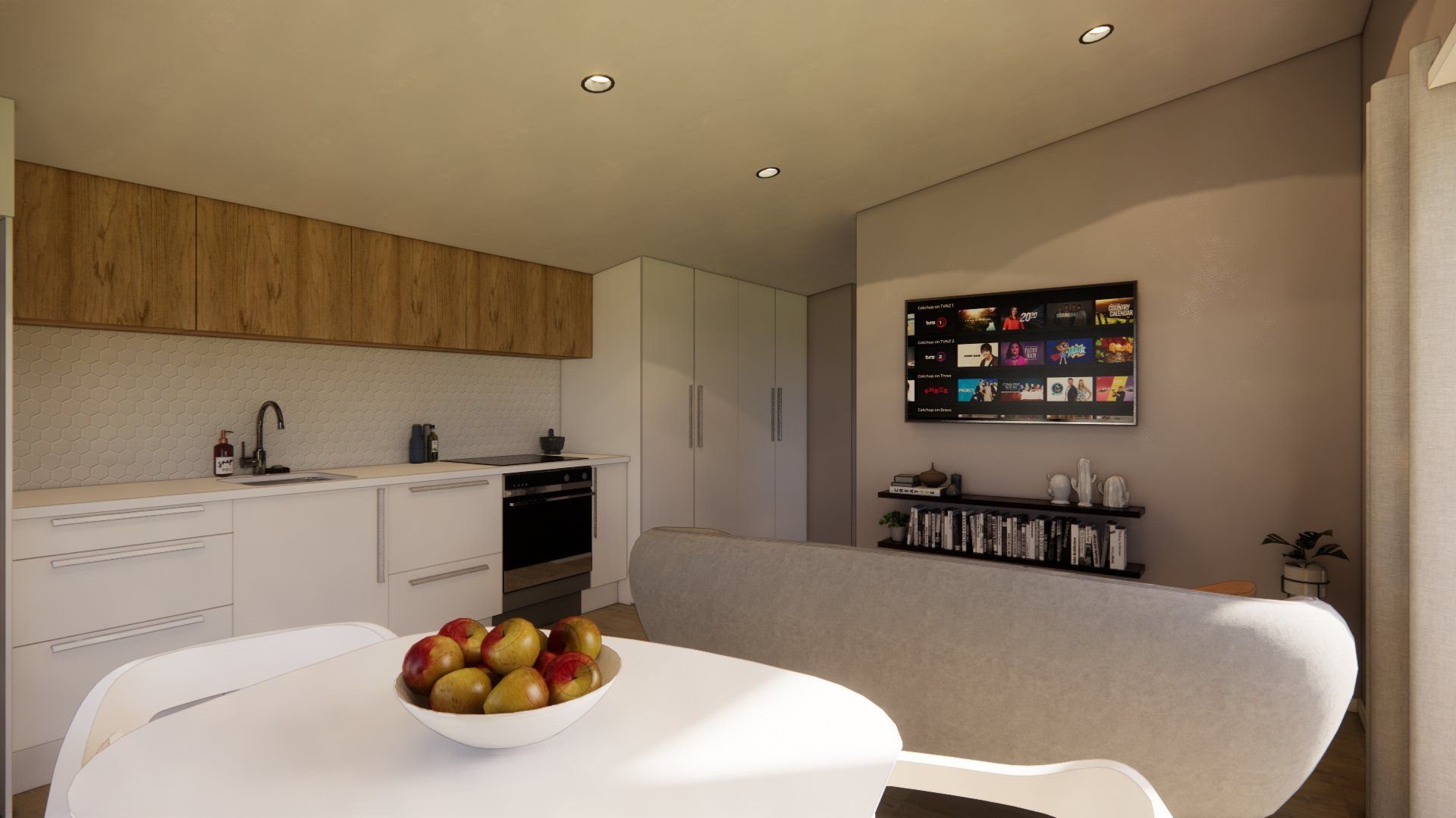 A bowl of fruit is on a table in a kitchen.