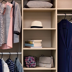 A closet filled with clothes hats books and a purse