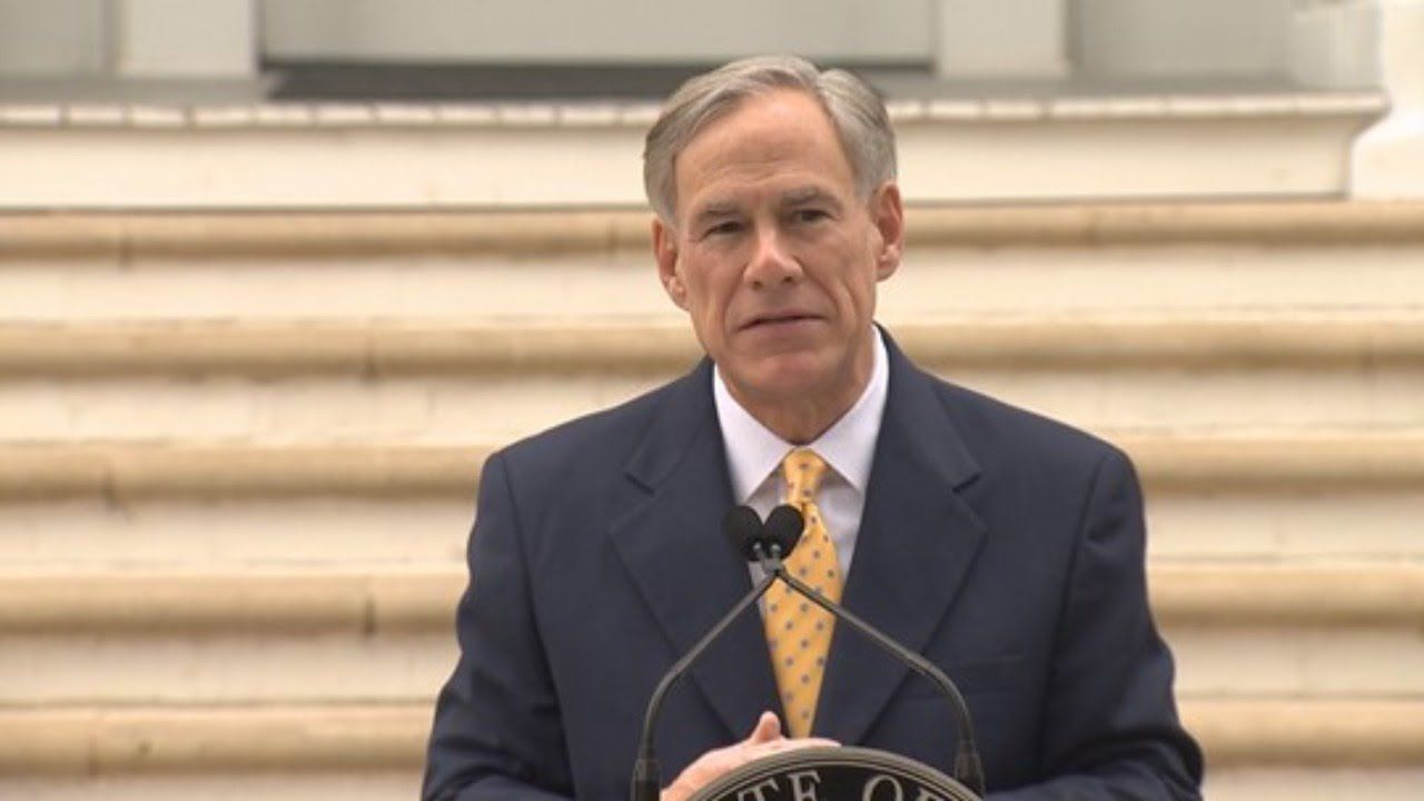 A man in a suit and tie is giving a speech at a podium.