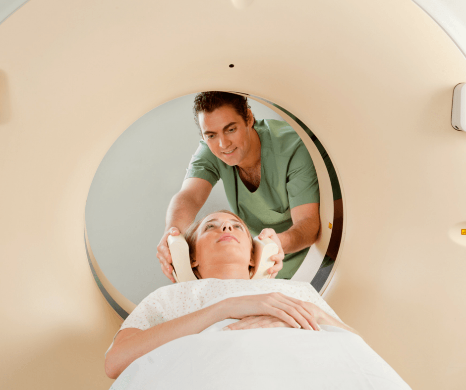 patient in MRI machine being helped by doctor
