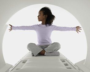 Bambina con capelli scuri all'interno di macchinario radiologico digitale