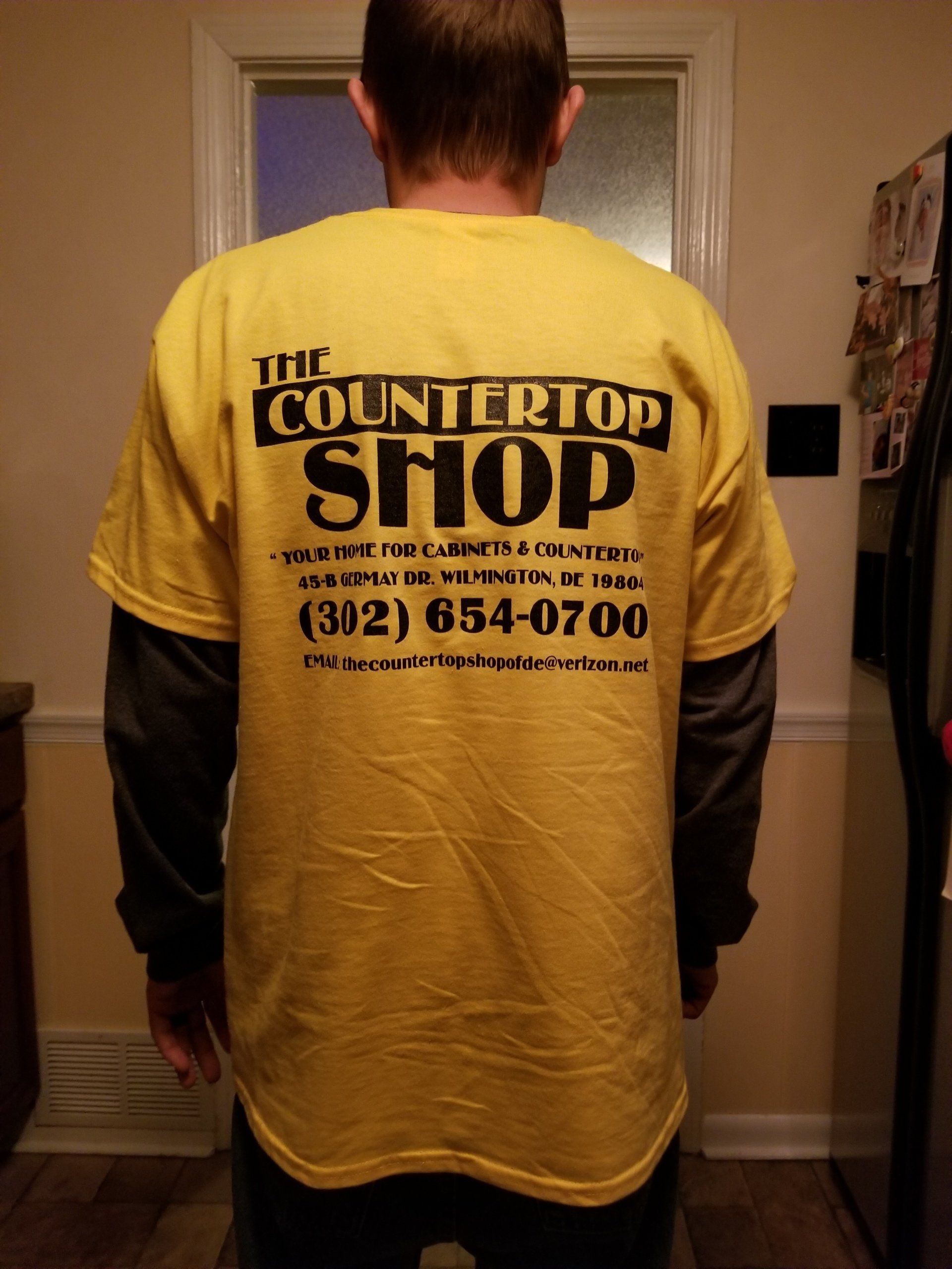 Crown Molding — A Man Wearing a Yellow T-shirt with The Countertop Shop Information at the Back in Wilmington, DE Crown Molding — A Man Wearing a Yellow T-shirt with The Countertop Shop Information at the Back in Wilmington, DE