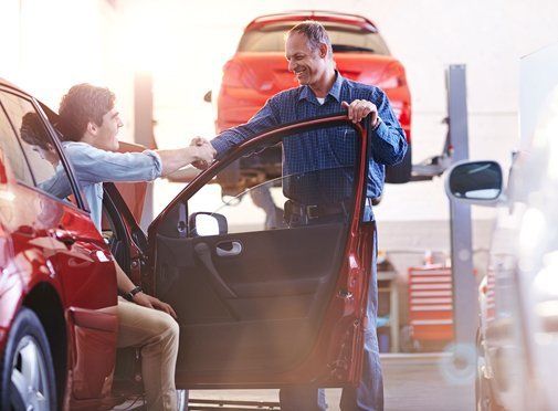 customer shaking hands with the mechanic 