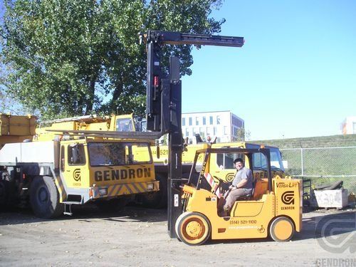 A gendron truck is parked next to a forklift