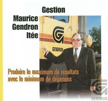 A man in a suit and tie is standing in front of a truck that says g on it