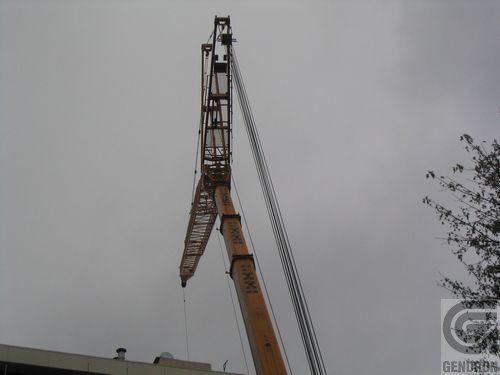 A large crane is being used to lift something in the air