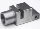 A close up of a metal object on a white surface.
