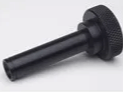 A close up of a black plastic handle on a white surface.