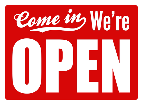 Red and white “Come in We’re OPEN” sign on a store door