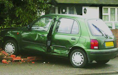   crashed car into brick wall  