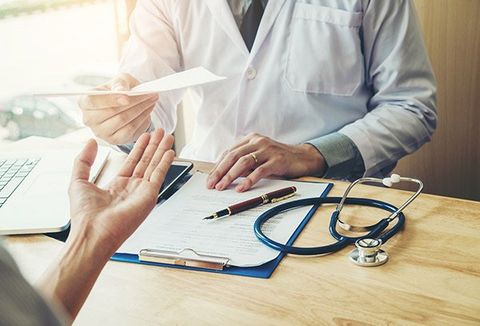 Sports Physicals — Doctor giving medical prescription to patient in Saint Helena, CA