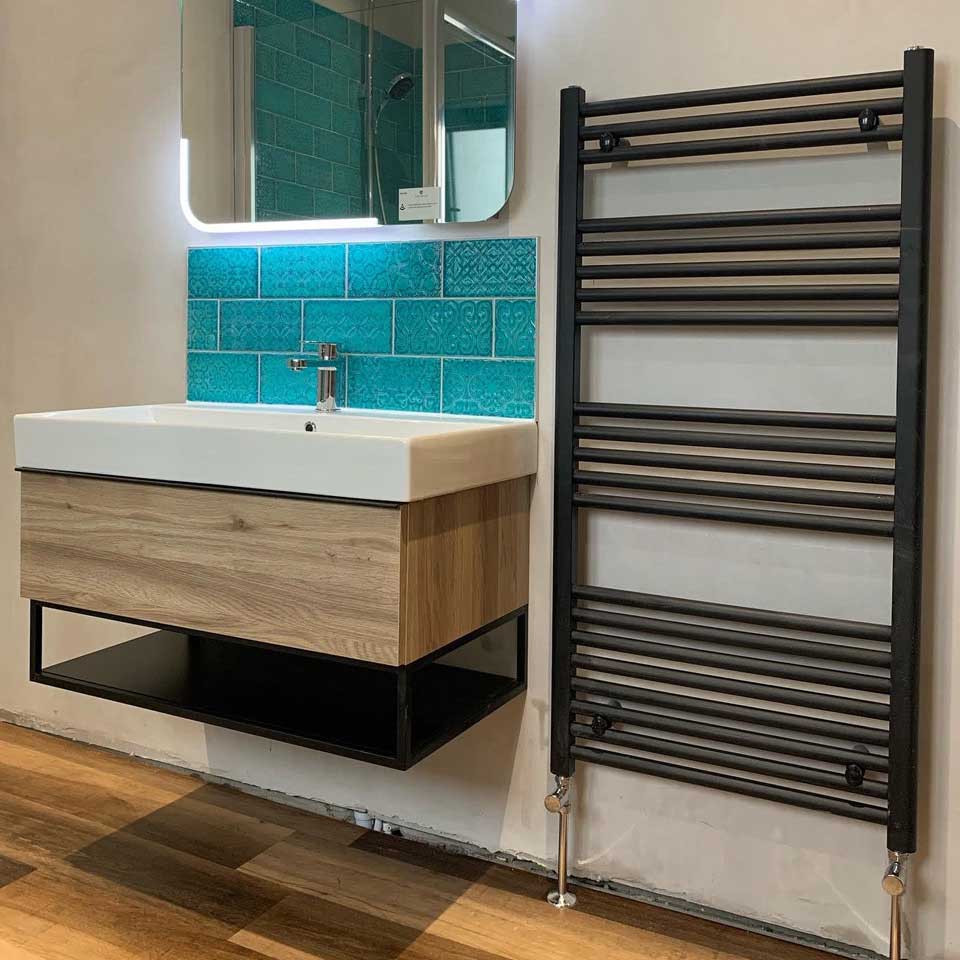 sink with turquoise tiles and heated rack