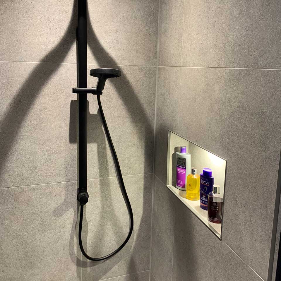 modern shower with built-in shampoo rack