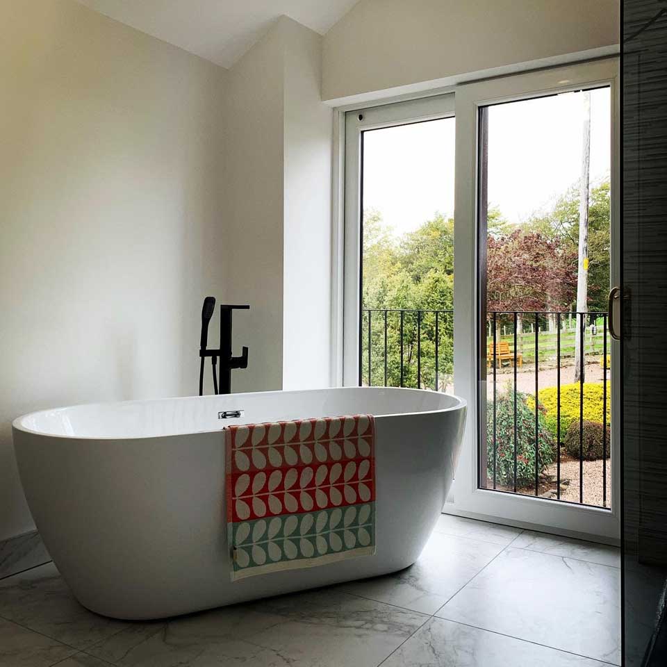 bathtub next to open window