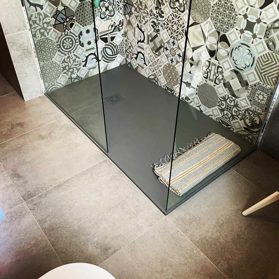 walk-in shower with ornate tiles
