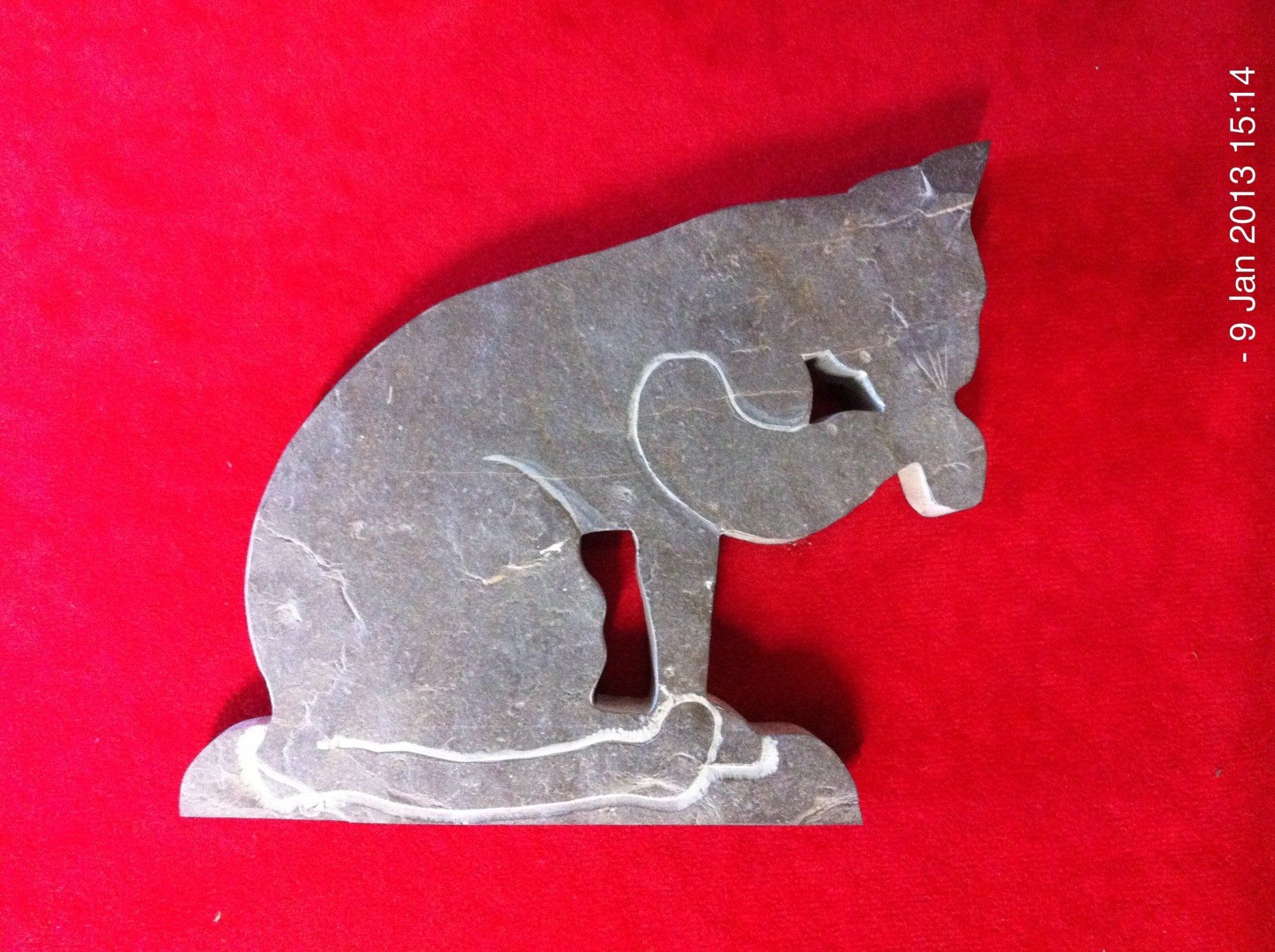 stone cat, cat grooming, cat cleaning, cat licking paw