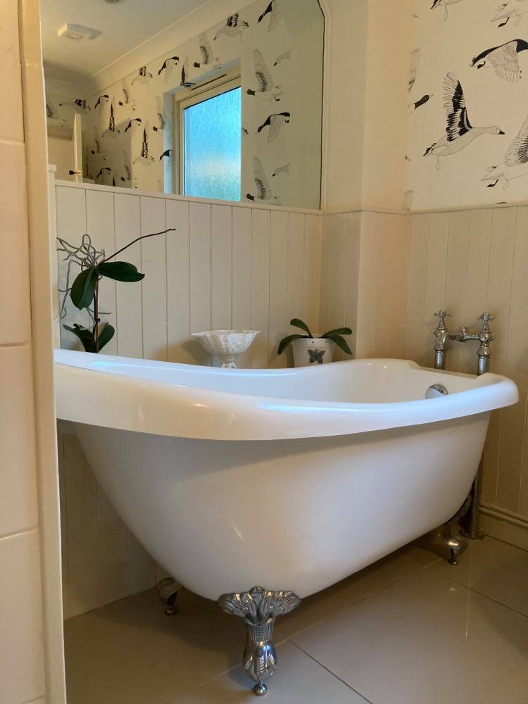 Large white roll-top bath