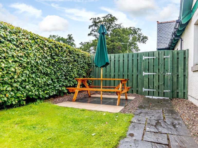 Garden picnic table with folded down parasol