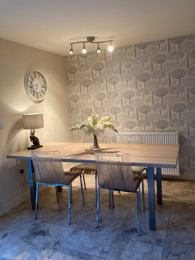 Dining table and chair with floral display on table