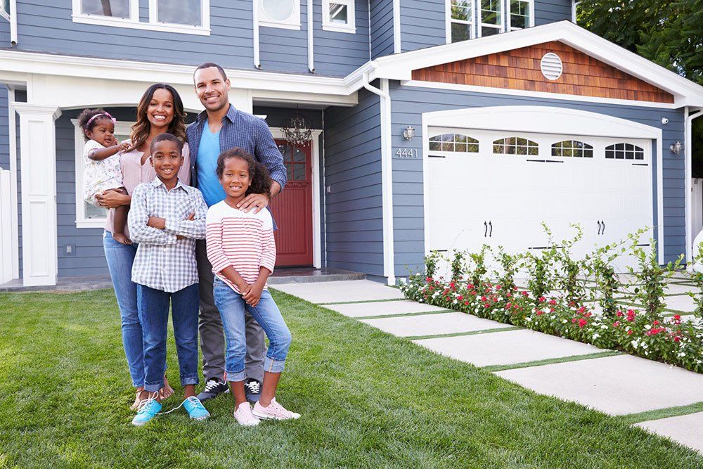 family standing outside of home