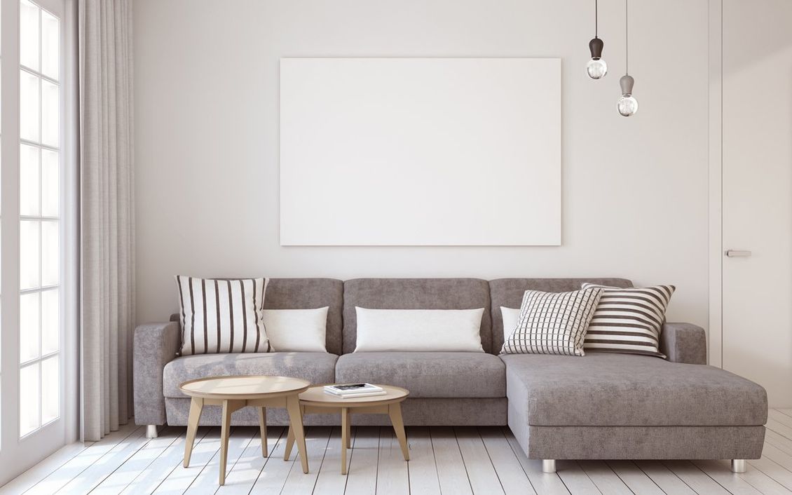 An interior living room with grey and tag design with lighting from a sliding glass door