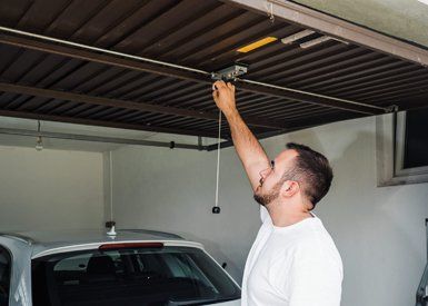 Home Garage Doors — Man Opens Garage Door in Glendale Heights, IL