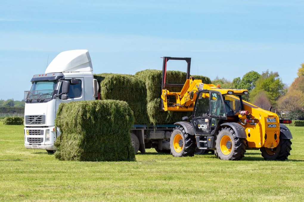 Truck Loading Up with Fresh Hay Bales — Deliveries in Gin Gin, QLD Truck Loading Up with Fresh Hay Bales — Deliveries in Gin Gin, QLD
