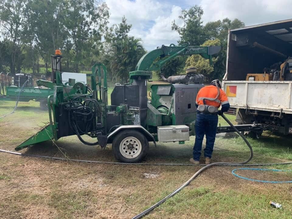 Man Working On Machine — Arborist in Yeppoon, QLD