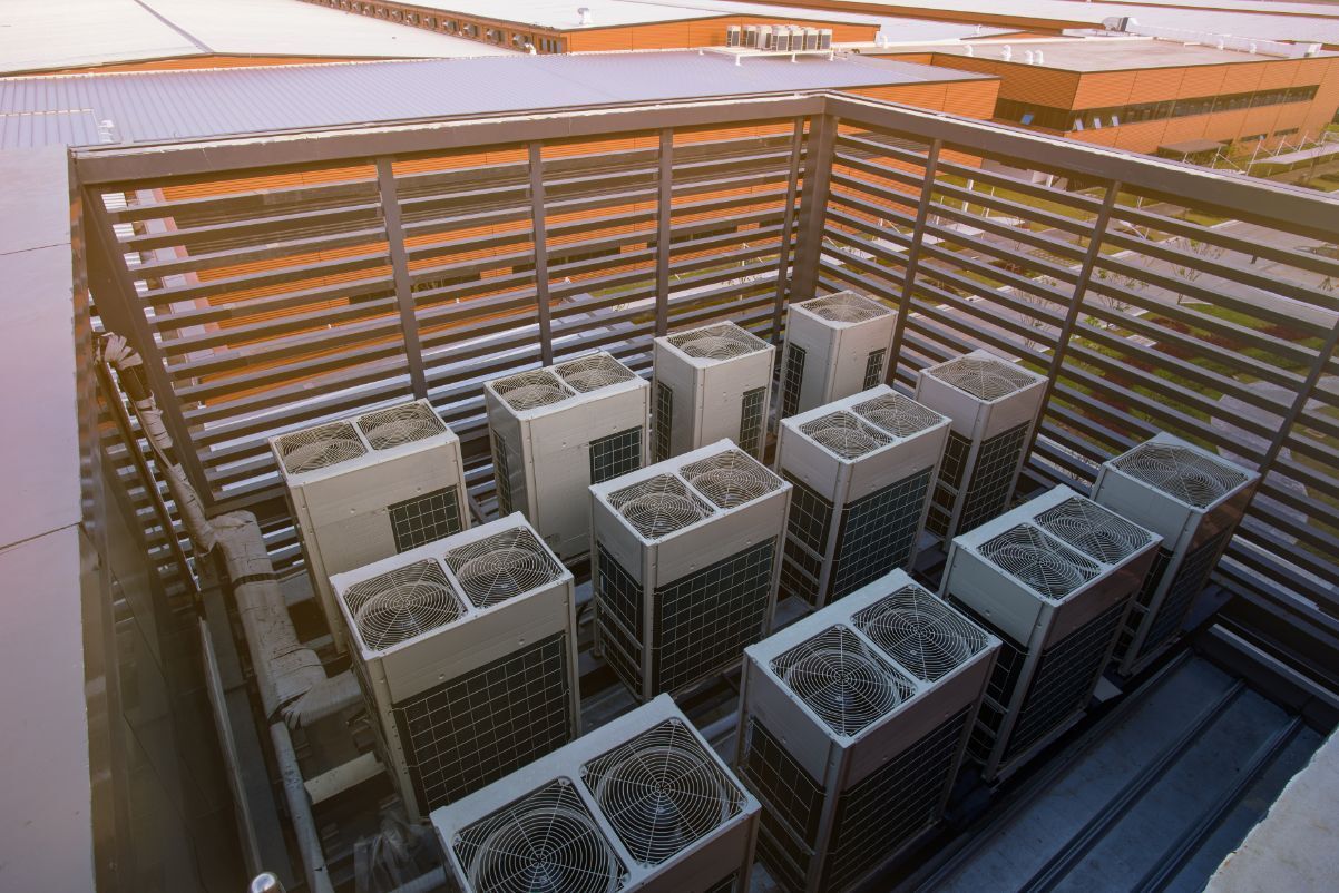 A Bunch of Air Conditioners Are Sitting on Top of a Building — Air-Con Cleaning Specialists in Redlynch, QLD