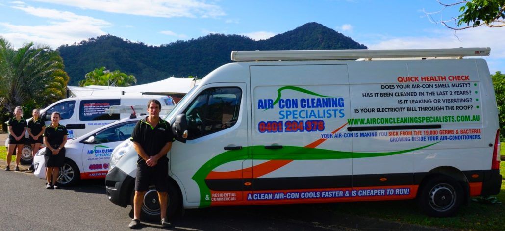 Professional Air Con Cleaners — Air Conditioner Cleaning In Cairns, QLD A Group of People Are Standing in Front of a Row of Vans — Air-Con Cleaning Specialists in Redlynch, QLD