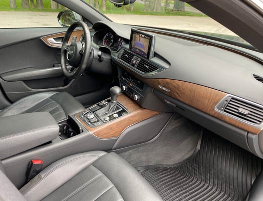 The interior of a car with a steering wheel and dashboard.
