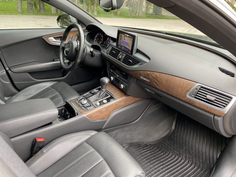 The interior of a car with a steering wheel and dashboard.