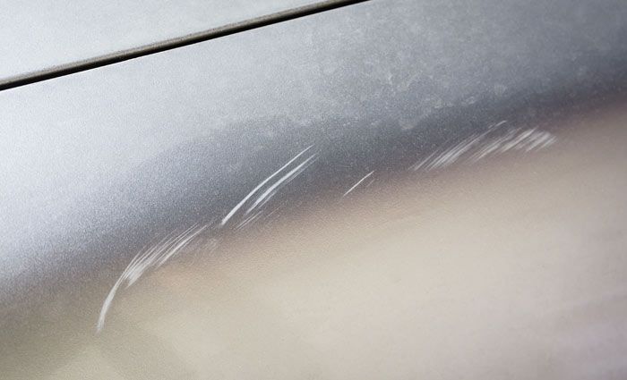 Car panel with surface scratches