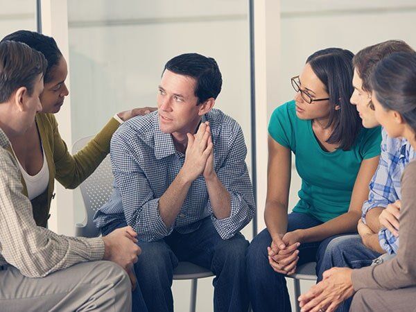 Woman Advising a Man in Group Therapy - Group Therapy in Warrenton, VA Woman Advising a Man in Group Therapy - Group Therapy in Warrenton, VA