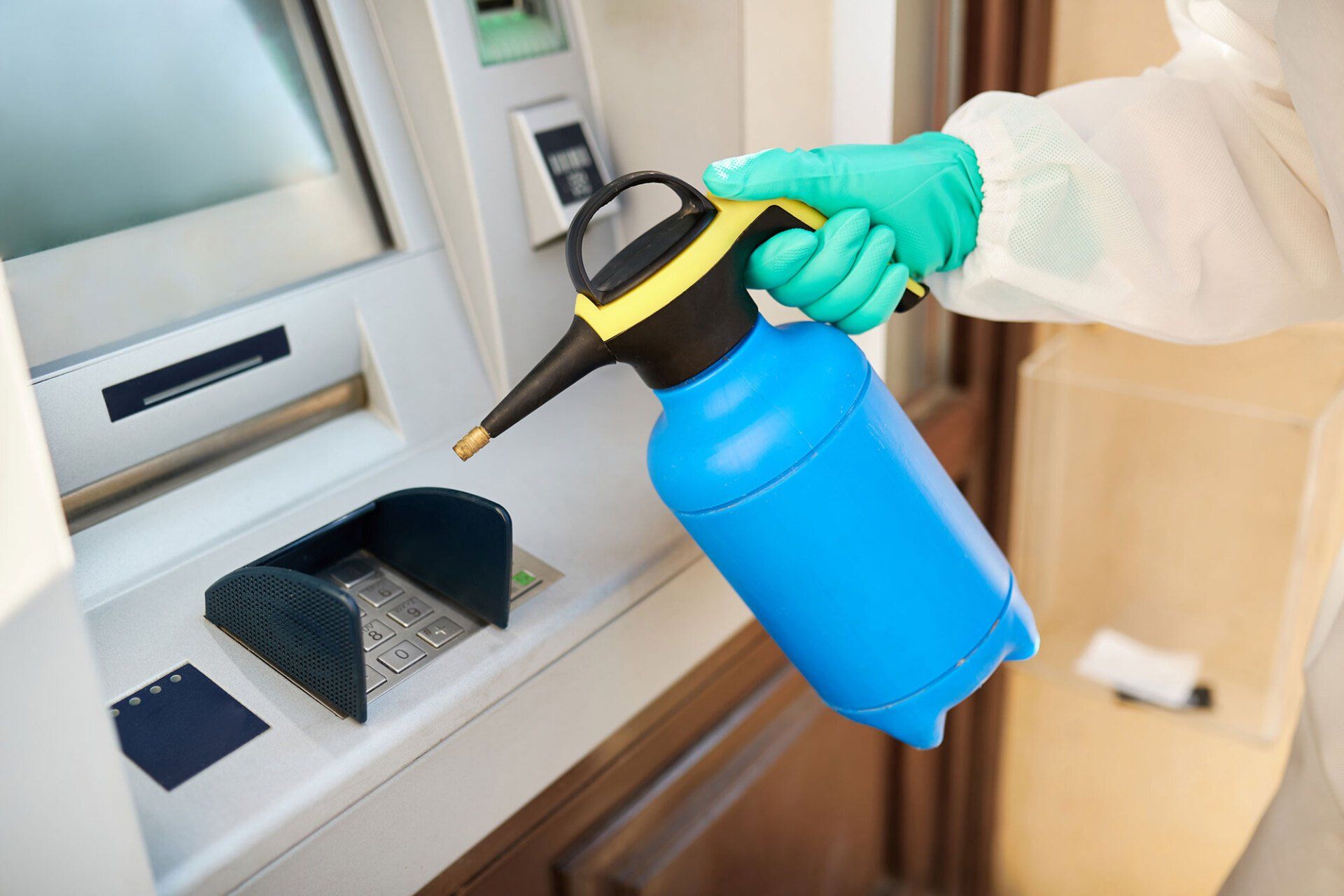 Worker Doing Disinfection of ATM — Indiana, PA — Keystone Dustless Mobile Media Blasting LLC