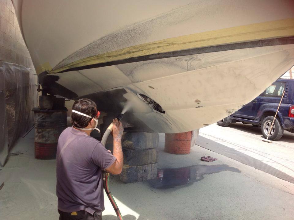 Man Working on Boat's Bottom Paint — Indiana, PA — Keystone Dustless Mobile Media Blasting LLC