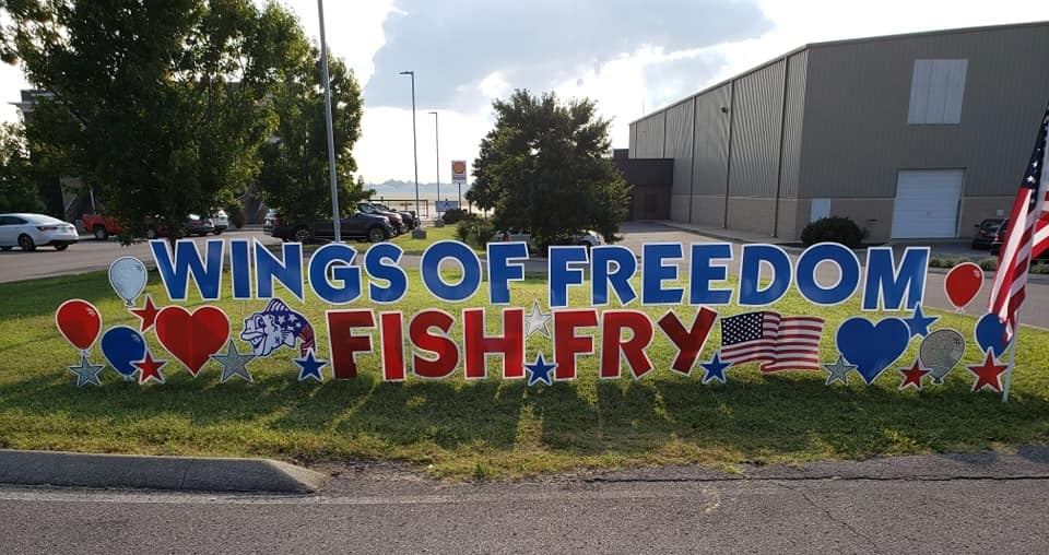 A sign that says wings of freedom fish fry